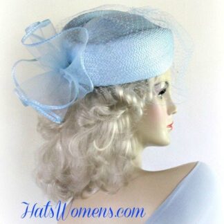 Women's Baby Blue Designer Pillbox Fashion Hat With A Bow And Birdcage Face Veil.