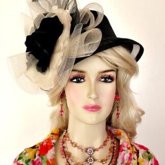 Ladies Black And Ivory Designer Haute Couture Fashion Dress Hat For Special Occasions, The Kentucky Derby Or The Kentucky Oaks Horse Race. This Avant Garde Headpiece Is Trimmed With A Sheer Black And Ivory Horse Hair Crin Bow, Accented With A Custom Made Black And Ivory Silk Millinery Flower. A Beautiful Dress Hat For A Wedding Guest Or Church. Custom Made And Designed By Women's Designer Hats At hatswomens.com - nyfashionhats.com.