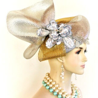 Women’s Dramatic Statement Metallic Silver Grey Gold Designer Pillbox Wedding Church Hat. This Hand Made High Fashion Hat Is Trimmed With A Large Metallic Gold And Silver Bow Enhanced With A Hand Painted Metallic Silver Grey Glass Beaded Large Flower. Small Satin Grey Flowers With White Pearls Are Placed Within The Handmade Flower. Placed Within And Around The Bowing Are Gorgeous Metallic Silver Sequin Glass Beaded Appliques. This Formal Wedding Hat Will Made A Feminine Fashion Statement. This Dressy Hat Can Be Worn In Different Positions. This Versatile Dress Hat Is Custom Made And Designed By NY Fashion Hats Couture Millinery, https://www.nyfashionhats.com. This Elegant Hat Is Part Of The Anastasia Konstandina Collection.