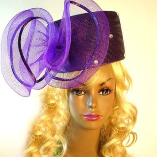 Ladies Couture Purple Pillbox Designer Fashion Hat With A Large Bow. This Custom Made Women's Designer Hat Is Embellished With A Huge Purple Crinoline Horsehair Bow, Accented With Acrylic Rhinestones. This Beautiful Designer Hat Is Suited For A Bride To Be On Her Wedding Day, Horse Races, The Kentucky Derby, Breeder's Cup, Maryland Million Day, Iroquois Steeplechase Horse Races, The Melbourne Cup, The Royal Ascot, Church, Weddings, Formals, And Special Occasion. This Fashion Hat Is Custom Made By Women's Hats, hatswomens.com.