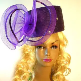 Ladies Couture Purple Pillbox Designer Fashion Hat With A Large Bow. This Custom Made Women's Designer Hat Is Embellished With A Huge Purple Crinoline Horsehair Bow, Accented With Acrylic Rhinestones. This Beautiful Designer Hat Is Suited For A Bride To Be On Her Wedding Day, Horse Races, The Kentucky Derby, Breeder's Cup, Maryland Million Day, Iroquois Steeplechase Horse Races, The Melbourne Cup, The Royal Ascot, Church, Weddings, Formals, And Special Occasion. This Fashion Hat Is Custom Made By Women's Hats, hatswomens.com.