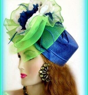 Royal Blue And Lime Green Fancy Pillbox Designer Cocktail Hat For Women. This Dress Hat Is Suited For Winter, Spring, Summer Or Fall. This pillbox hat is embellished with a large lime green ornate bow, adorned with ivory and royal blue flowers.  Delicate, royal blue feathers, give this hat such elegance. A Perfect Special Occasion Hat, To Wear To Church, A Wedding, Formals, Cocktail Parties, Tea Parties, Holiday's, Horse Races, The Kentucky Derby, The Belmont Stakes, The Preakness, And Polo Matches. Custom Made And Designed By NY Fashion Hats, www.nyfashionhats.com