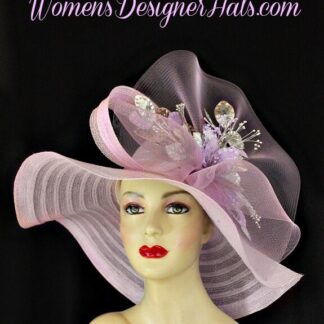 Ladies Haute Couture Soft Pastel Lilac Purple Splash Of Grape Lavender Designer Wide Brim Kentucky Derby Hat. This Custom Made Fashion Hat Is Trimmed With A Large Bow Made Of The Same Material Of The Hat And A Large Sheer Pastel Purple Crinoline Bow. Placed Within The Bow Are Hand Dyed And Sprayed Lavender And Metallic Silver Sequin Velvet Millinery Flowers With Silk Leaves.