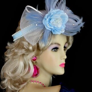 Women's Pastel Sky Baby Blue And White Custom Made Cocktail Hat, Wedding Fascinator, Flower Halo, Crown Half Hat, With A Custom Made Blue Silk Flower. Beautiful Wedgewood Blue Feathers, Are Placed With The Large White Sheer Netting Bow. Glass Rhinestones, Give This Headpiece Such Style. This Hair Accessory Hat, Can Be Worn Like A 1920' Flapper Hat. Also Suited For Art Deco Parties. This Formal Brides Headpiece, Is Suited For Winter, Spring, Summer Or Fall. We Specialize In Cocktail Hats For Women, Pillbox Hats With Veils, Wedding Fascinators, Hats With Feathers, Satin Dress Hats For Women, Hairband Hats, Bridal Headpieces, Hats For Brides, Hair Accessories For Women, Custom Designer Hats, Kentucky Derby Hats, Hats For Horse Races, Hats For Formals, Church Hats, And Special Occasion Hats. Custom Made And Designed By NY Fashion Hats Custom Millinery Headwear. https://www.nyfashionhats.com