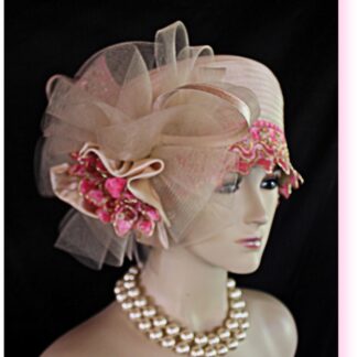 Beige Pink Metallic Gold Formal Haute Couture Satin Embroidered Pillbox Designer Fashion Hat. This Elegant Dress Hat Is Embellished With A Satin Sculptured Decorative Metallic Gold And Pink Extension Bow. The Same Beautiful Metallic Gold And Pink Trim Encircles The Lower Portion Of The Crown. A Large Horsehair Bow Mixed With Satin Loop Bowing Is Also Adorned On This Glamorous One Of A Kind Hat. Mixed Within This Bowing Is A Beige Satin Bow With A Metallic Gold And Pink Embroidered Bow Enhanced With A Hot Pink Satin Rosette. This Hat Talks For Itself, It Will Make A Huge Hit. This Dramatic Hat Can Be Worn In Different Positions To Suit Your Face.