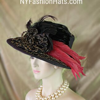 Haute Couture Black And Metallic Gold Embroidered Designer Hat For Women. This One Of A Kind Statement Dress Hat Is Embellished With A Black Bow Enhanced With A Handmade Black And Metallic Gold Embroidered Bow. Expensive Black Hackle Rooster Feathers Are Placed Within This Exquisite Bowing Topped Off With Pink Long Coque Feathers. The Feather Colors Are Between A Red And A Pink. A Black Hat Band Encircles The Crown Of This High Fashion Hat. Black Rhinestone Trim Is Placed Withing The Bowing.