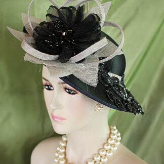Women's Haute Couture Black Satin Grey Sinamay And Metallic Silver Formal Designer Shallow Brim Hat.  This fashion hat is embellished with a large handmade silver gray sinamay straw loop flower petal bow. Placed within this elaborate bow is a black handmade organza bow enhanced with wired glass beaded flower petals adorned with a glass rhinestone. Glamorous black sequin glass beaded rhinestone floral appliques are placed around the hat. A very expensive glass rhinestone trim encircles the crown of this high fashion hat. You will definitely be noticed wearing this statement designer hat.