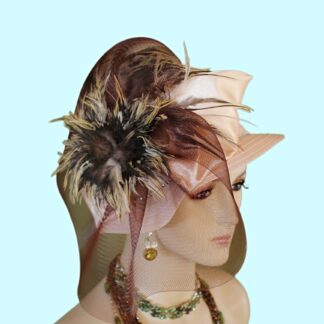 Women’s Elegant Beige And Brown Haute Couture Small Brim Designer Hat Suited For Brides Or Wedding Guests. This Hand Made High Fashion Hat Is Trimmed With A Large Dark Brown Horsehair Crinoline Bow Enhanced With A Handmade Golden Vanilla Beige Satin Large Bow. Embellished Within This Beautiful Bowing Are Expensivel Multi Colored Rooster Hackle Feathers. Colors Include Beige Brown Ivory Copper Feathers. The Color Combination Of Feathers Is Just Gorgeous. A Delicate Rhinestone Trim Encircles The Lower Portion Of The Crown On This Amazing Hat.