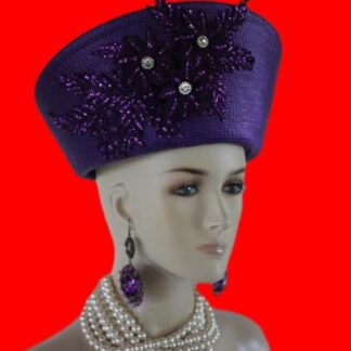 Purple Haute Couture High Crown Nefertiti Style Women's Pillbox Hat Headdress, Formal Wedding Dress Mother Of The Bride Hat. This Glamorous Avant Garde Hat Is Made And Designed By NY Fashion Hats Millinery For Women. This Beautiful Hat Is Adorned With A Large Handmade Purple Sequin Glitter Rhinestone Floral Flower Design. This Hat Is A Show Piece.