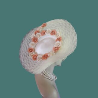 Step into a realm where tradition meets the extraordinary with the Ladies Ivory Beige Formal Wedding Scallop Weave Large Lift Up Brim Sculptured Pillbox Hat, an audacious accessory that redefines sophistication. Crafted by the visionary artisans at NYFashionHats.com, this hat is not merely an accessory; it’s a bold declaration of style, designed for the modern connoisseur of fashion.
