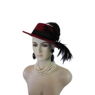 Elvolve into the realm of haute couture with the Ladies Burgundy Red Wine Gondola Bolero Gaucho Designer Hat—a true masterpiece that embodies the elegance and sophistication of high fashion. This striking boater-style hat, meticulously crafted by the renowned artisans at NYFashionHats.com, showcases an exquisite blend of sumptuous black rooster hackle feathers. Its daring design redefines what it means to make a fashion statement, ensuring that all eyes are on you at every occasion.