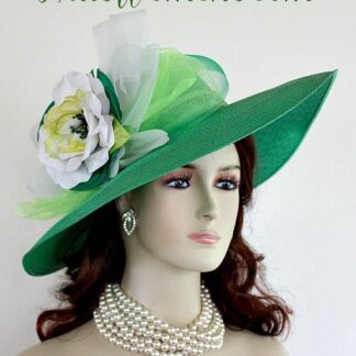 Ladies Kelly Green Wide Brim Formal Haute Couture Fashion Kentucky Derby Hat With Expensive Silk Millinery Flowers. This Custom Made Women's Designer Hat Is Embellished With A Large Kelly Green Crinoline Horsehair Bow, Mixed With A Lime Green Organza Bow. Beautiful Silk Handmade White, Lime And Kelly Green Flowers Are Placed In The Center Of This Bow.  A Hand Dyed Beaded Lime Green Velvet Trim Encircles The Crown Of This Fashion Hat. This Gorgeous Designer Hat Is Suited For A Bride To Be On Her Wedding Day, Horse Races, The Kentucky Derby, Breeder's Cup, Maryland Million Day, Iroquois Steeplechase Horse Races, The Melbourne Cup, The Royal Ascot, Church, Weddings, Formals, And Special Occasion. This Fashion Hat Is Custom Made By Women's Hats, hatswomens.com.