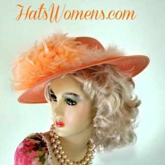 Ladies Peach Or Pastel Orange Designer Wide Brim Wedding Special Occasion Formal Hat. This Peach Formal Custom Made Church Hat, Is Trimmed With Peach Chandelle Feathers. Delicate Ivory Colored Fur Like Feathers Incircle The Crown Of This Hat, Giving This Hat Such Elegance.